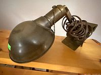 Entire lamp side view showing shade, arm, cord, mount