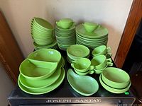 Full lot of stacked green melamine dinnerware pieces