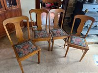 Four matching oak chairs, front view