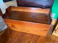 Front view of wooden storage bench closed