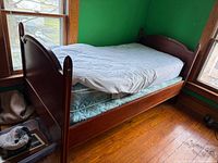 Full view of assembled twin bed showing wood frame, mattress, box spring