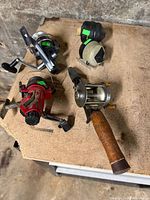 overview of five fishing reels on table
