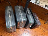 Five pieces of hard-shell luggage lined on floor