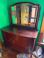 Front view of dresser and attached mirror showing broken glass and overall design