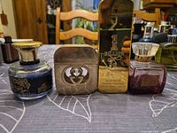 Group shot of all four perfume and cologne bottles on tabletop