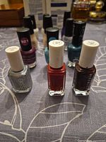 Front view showing Essie silver, red and plum plus assorted behind
