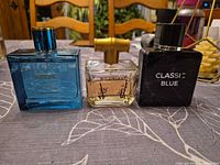 Front view of all three perfume bottles: Europe, Wildwood, Classic Blue