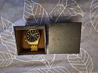Watch in open Michael Kors box, lid beside