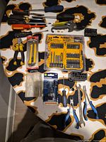 Full lot overview showing all hand tools, driver bit set, pliers, screwdrivers, utility knife, nails/pins box, bulb package