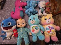 Group shot of all nine plush toys on table