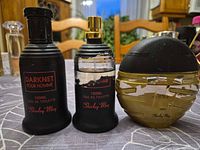 Front view of all three Shirley May 100 ml eau de toilette bottles showing branding, shapes and paint wear