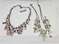 Both necklaces laid flat showing overall designs