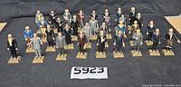 All thirty-four Marx president figures displayed upright on dark fabric backdrop