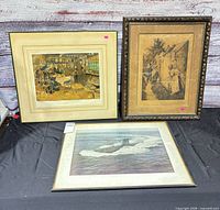Group shot of three framed prints on table