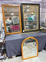 All three wood-framed mirrors on table