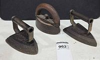 Group shot of three antique sad irons