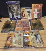 Group shot of nine sealed Buffy the Vampire Slayer action figures in original packaging arranged on table