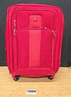 Front view showing full suitcase, wheels, front pocket, logo