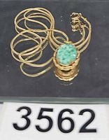 Entire necklace coiled showing pendant front