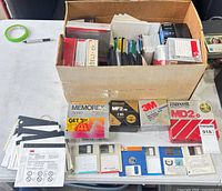 Overall lot with open box of mixed loose disks and three sealed retail boxes