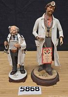 Front view of both signed terracotta doctor and dentist figurines