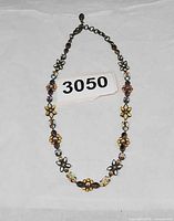 Full view of necklace laid flat with lot number visible