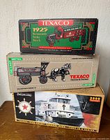 Stacked boxes showing Kenworth stake truck, Horse & Tanker, Fire Chief tug boat