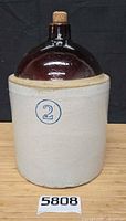 Front view of assembled jug in crock with cobalt 2 mark and cork stopper visible