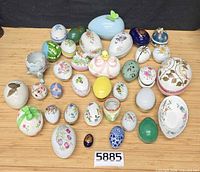 Group shot of all decorative eggs and chicken egg cup laid out on table