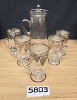 Full set showing pitcher with lid and five mugs