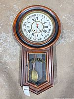 Full view of wall clock showing entire case and dial