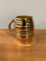 Front view of gold Labatt’s award mug showing handle, logo and inscription