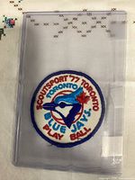 Front view of embroidered patch inside protective sleeve