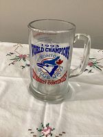 Front view of glass mug showing logo and World Champions text