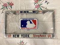 Front view of sealed metal license plate frame showing MLB and Yankees branding