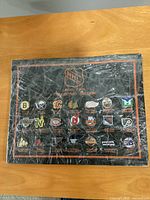 Front view of wrapped display board showing 21 NHL logo pins