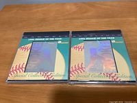 front view of both sealed hologram cards showing player names and packaging