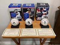 Three replica signature baseballs on stands with boxes and COAs