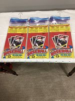 Front graphics of three flat O-Pee-Chee boxes in bags