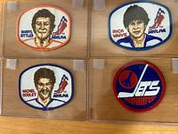 Four embroidered hockey patches: Darryl Sittler, Rick Vaive, Michel Goulet NHLPA ovals, and Winnipeg Jets round logo