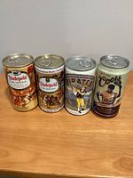 Front view of four commemorative MLB beer cans