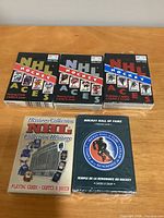 Five sealed NHL themed playing card decks placed on table