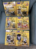 Front view of six sealed 1998 Starting Lineup NHL action figures on yellow cards