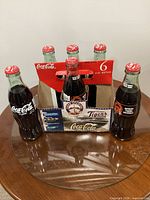 Six sealed 8oz Coca-Cola bottles in commemorative Detroit Tigers carrier on table