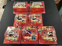 Seven factory-sealed 1999 Starting Lineup Pro Action NHL figures in original packaging displayed on table