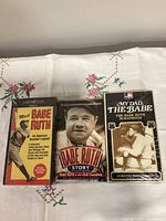 Front view of Babe Ruth book and two sealed VHS tapes