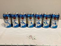 Front view of first seven cans showing slogans A White Wash, The Swingin’ Twins, Royal Flush, Brand ’Em, Fallin’ Angels, Bon Voyage Mariners and Kiss Your A’s Goodbye