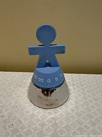 Front view of blue-topped Alessi Girotondo timer showing dial
