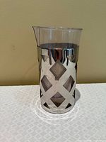 Front view of stainless steel holder with plastic insert