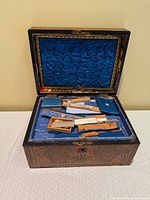 Open vanity case showing blue satin interior and grooming accessories